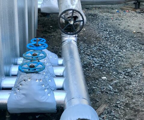 Asphalt processing facility. Fiberglass pipe and reusable valve insulation covers.